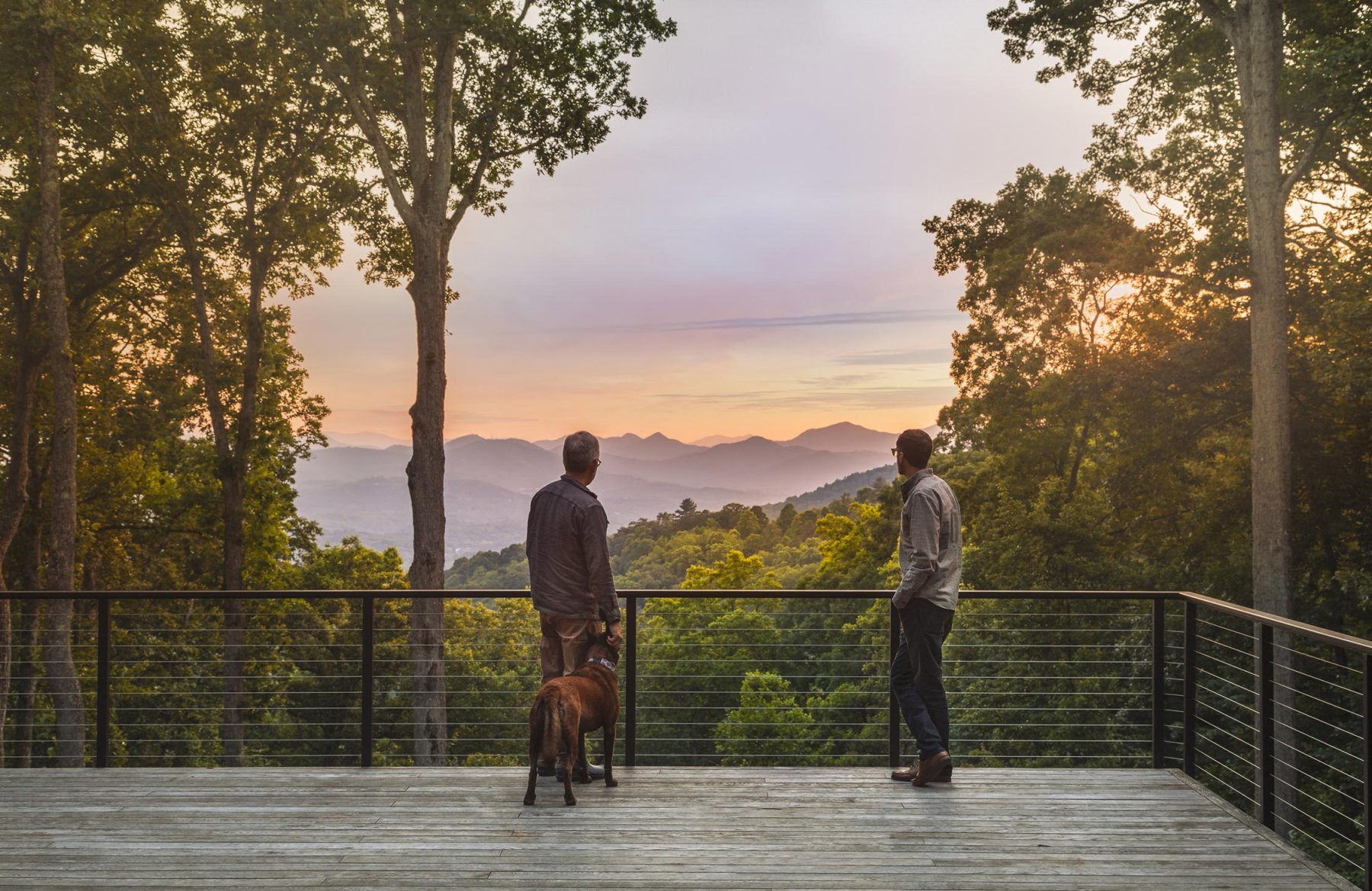 Osada Construction - prioritizing our experienced team view of staff on a balcony looking out at mountain views
