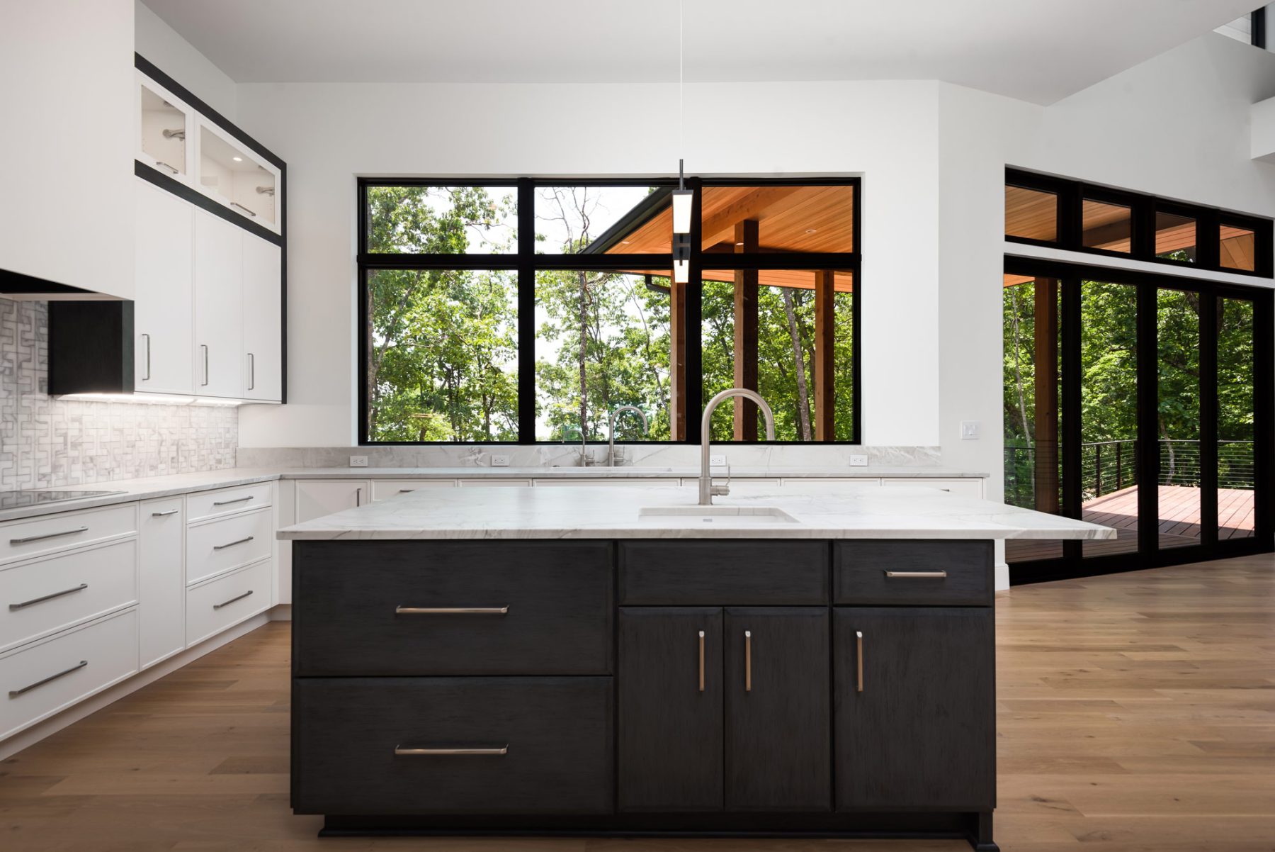 Southcliff Custom Home Builder - A stunning two-story deck perfectly captures the views from this Modern Prairie-style home sitting at a 3,850 ft elevation. The home is situated perfectly on the site, ensuring spectacular views from every room by Osada Construction