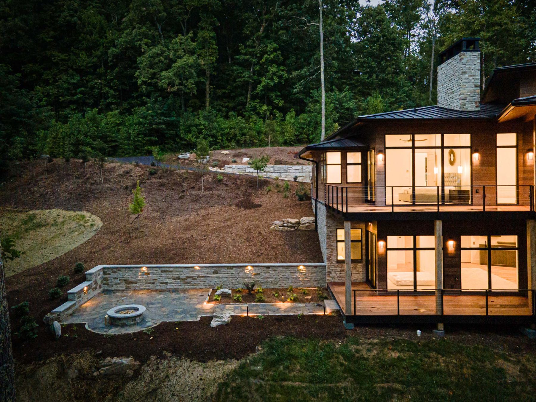 Southcliff Custom Home Builder - A stunning two-story deck perfectly captures the views from this Modern Prairie-style home sitting at a 3,850 ft elevation. The home is situated perfectly on the site, ensuring spectacular views from every room by Osada Construction