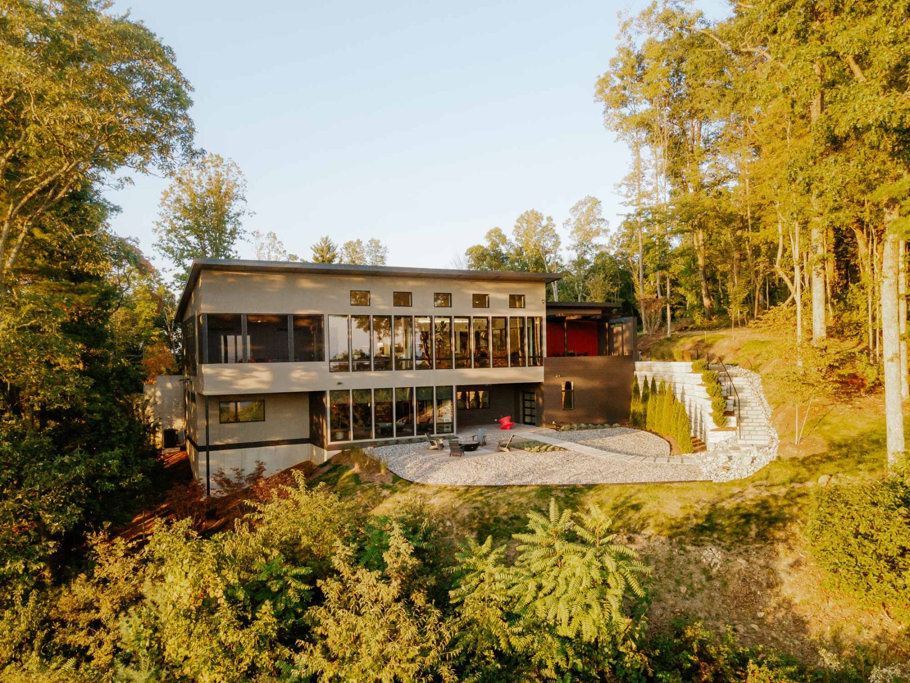 Home Builder Asheville. The blend of ultra-contemporary features sleek, monochromatic finishes with window wall for stunning city views by Osada Construction.