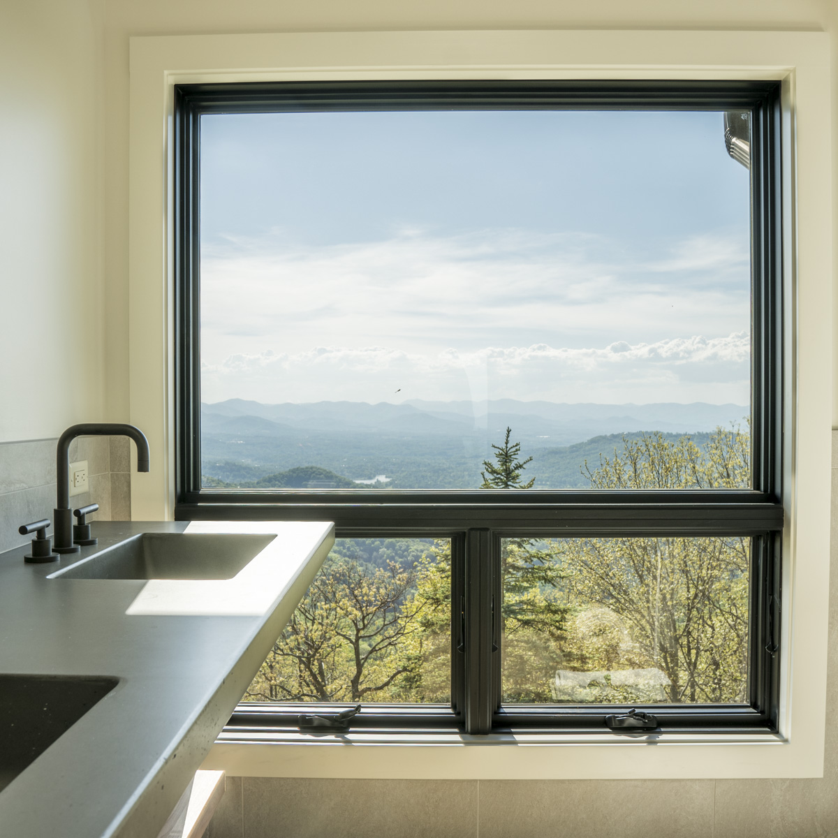 Asheville Midcentury Renovation - after owners bath view by Osada Construction