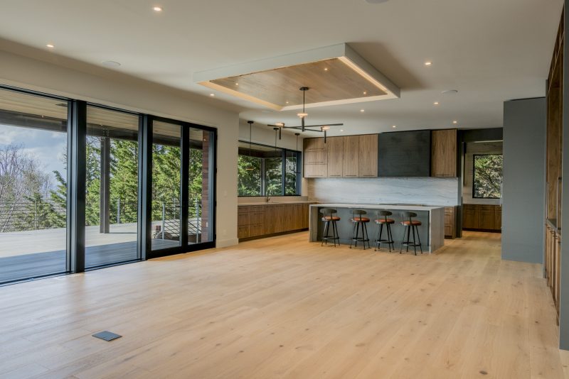 Modern Asheville Renovation after unfurnished dining and kitchen space by Osada Construction